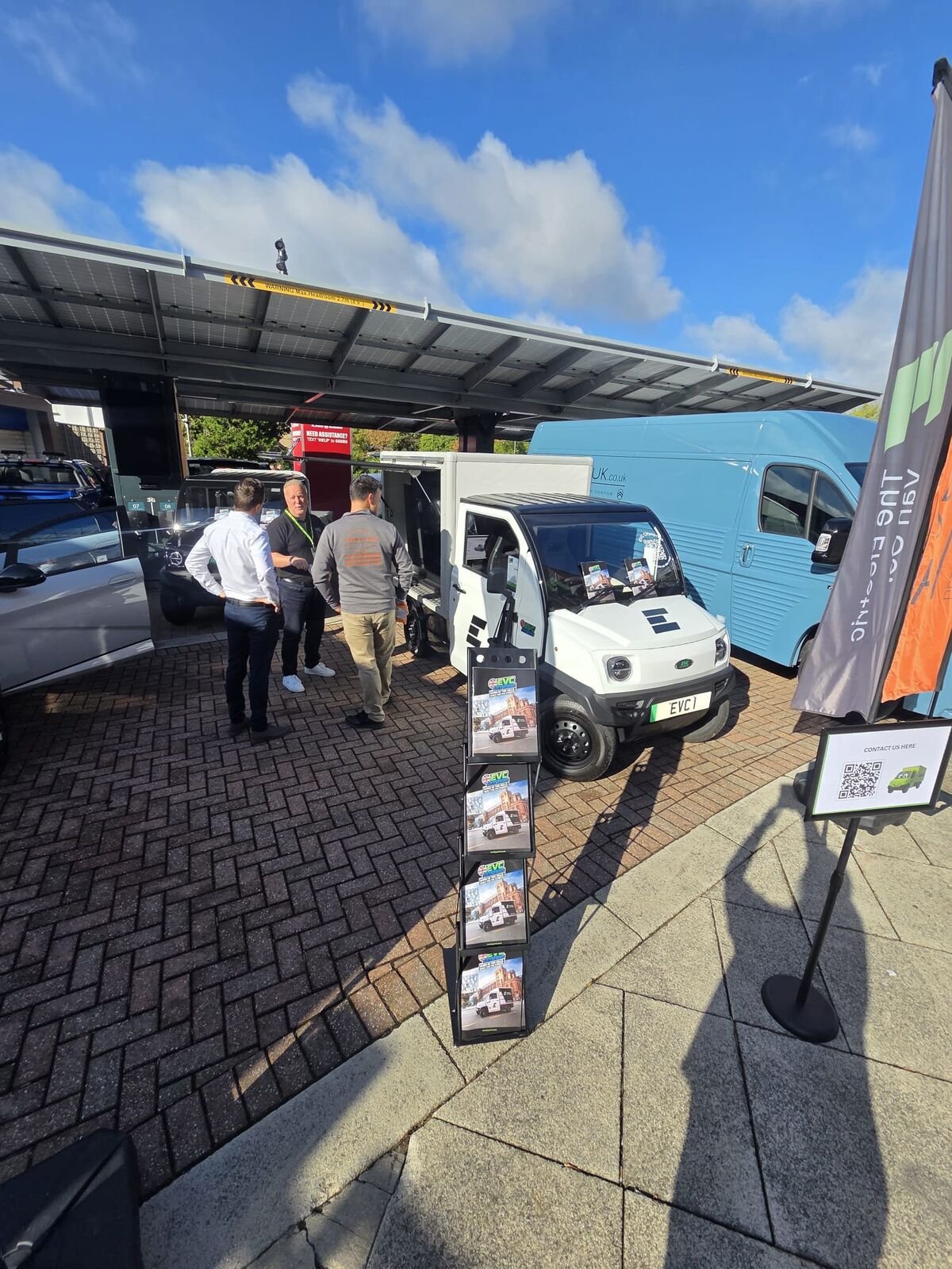 Visitors on the EVC stand under blue skies